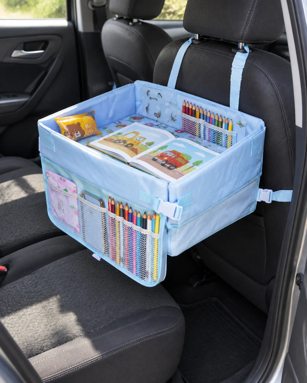 Show this exact foldable kids car travel tray attached to a real back seat, holding drawing material
