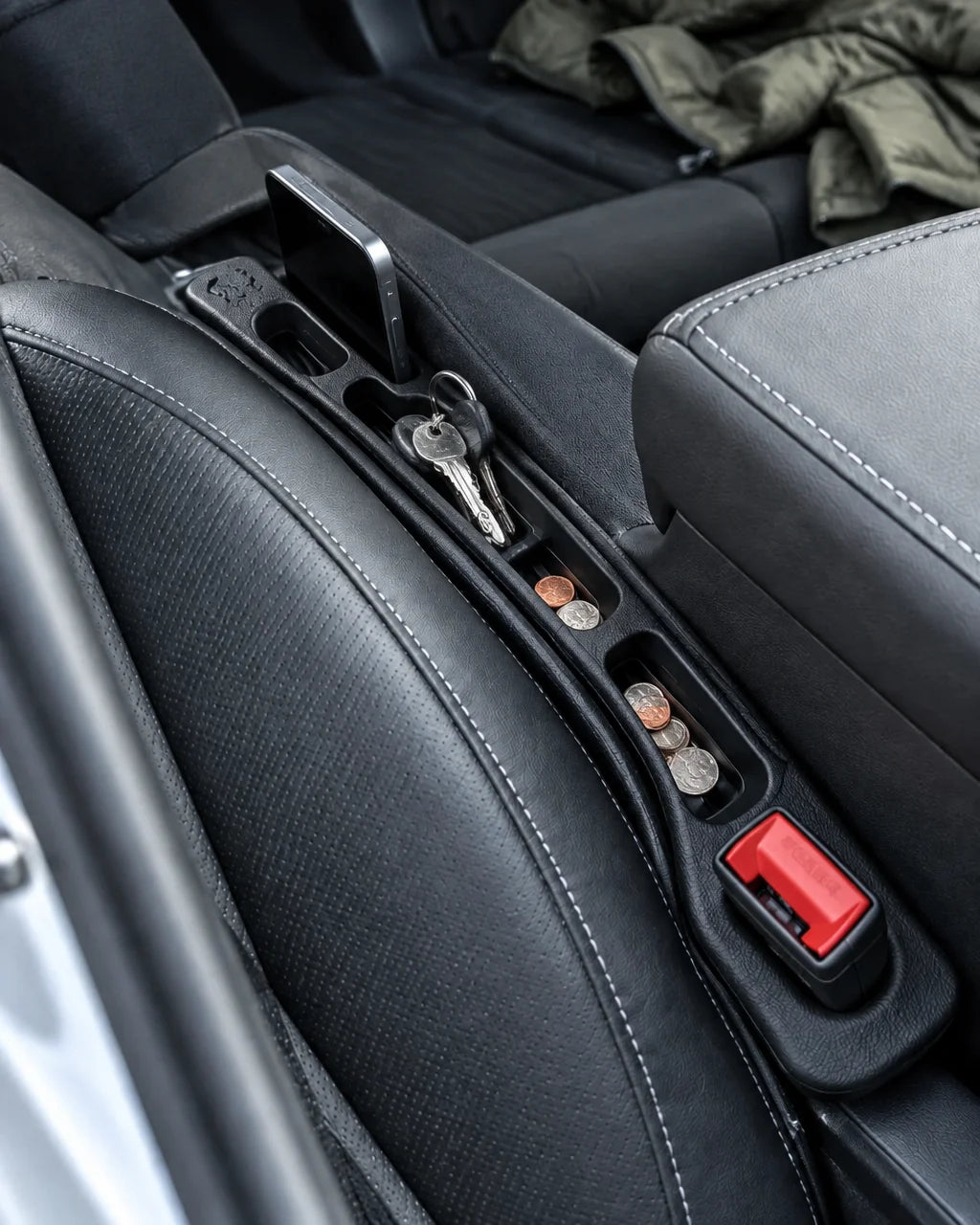 Show this exact seat-gap car organizer fitted between the front seat and center console of a real ve