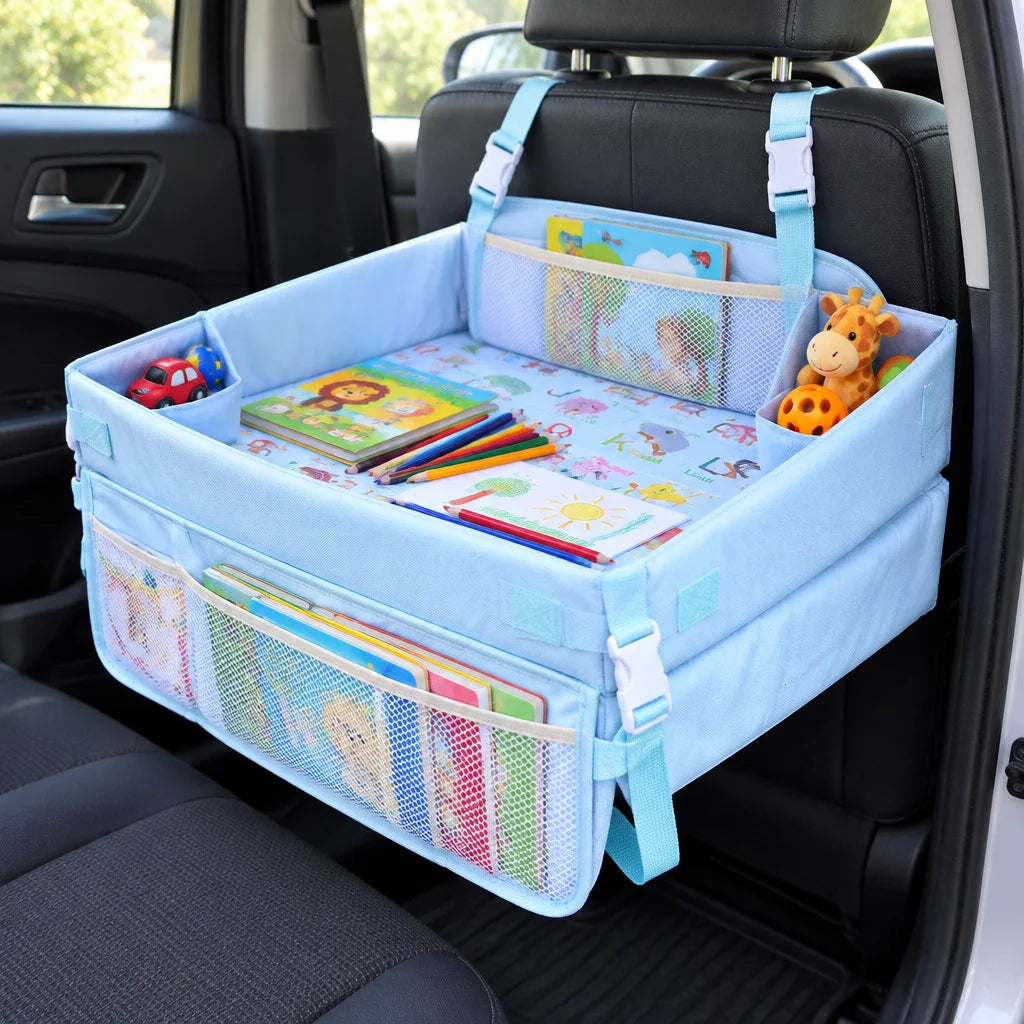 Show this exact foldable kids car travel tray open in a real back seat with books, toys, and drawing