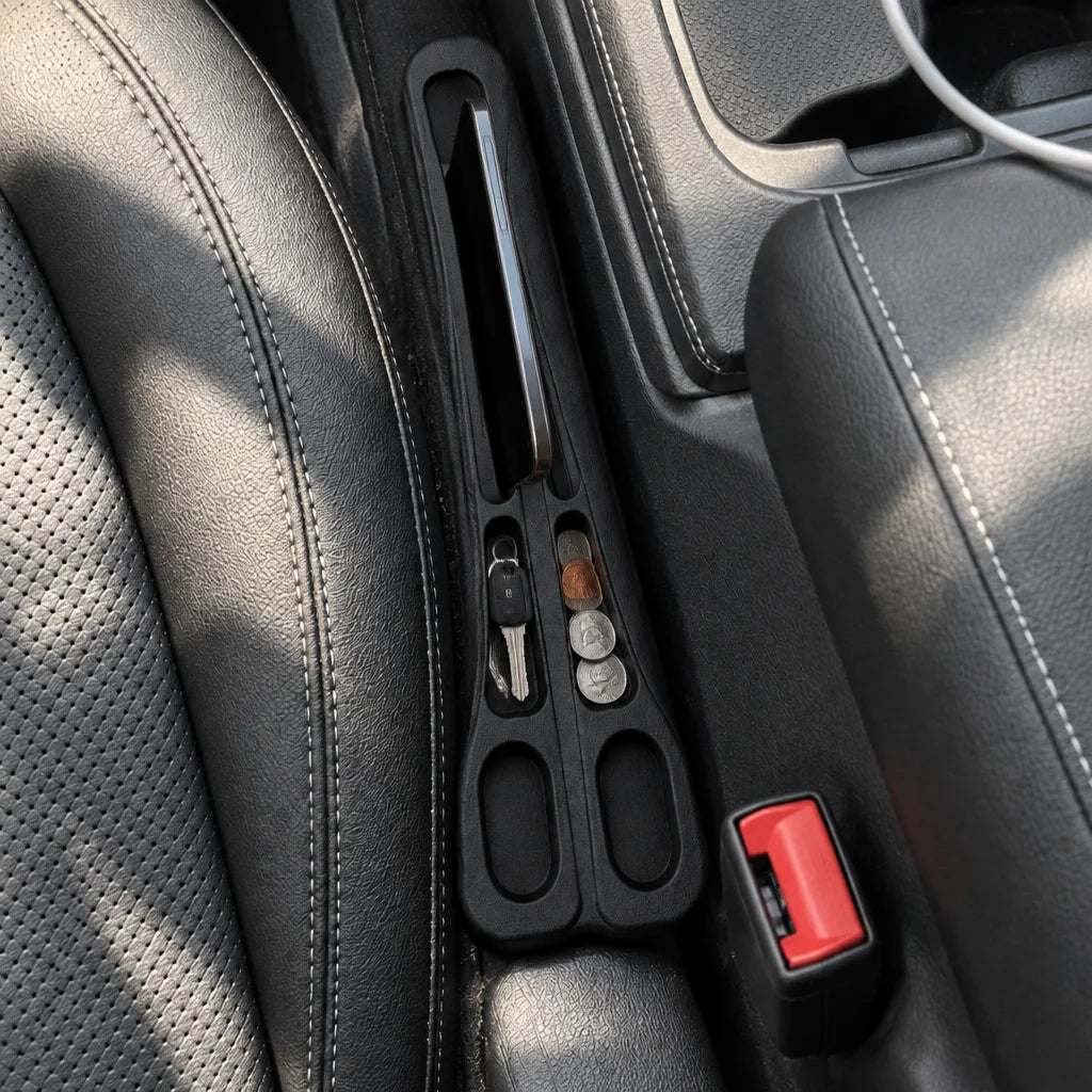 Show this exact seat-gap car organizer from above in a real car interior, with its compartments hold