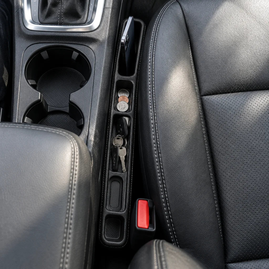 Show this exact seat-gap car organizer from above beside the center console, with its compartments a